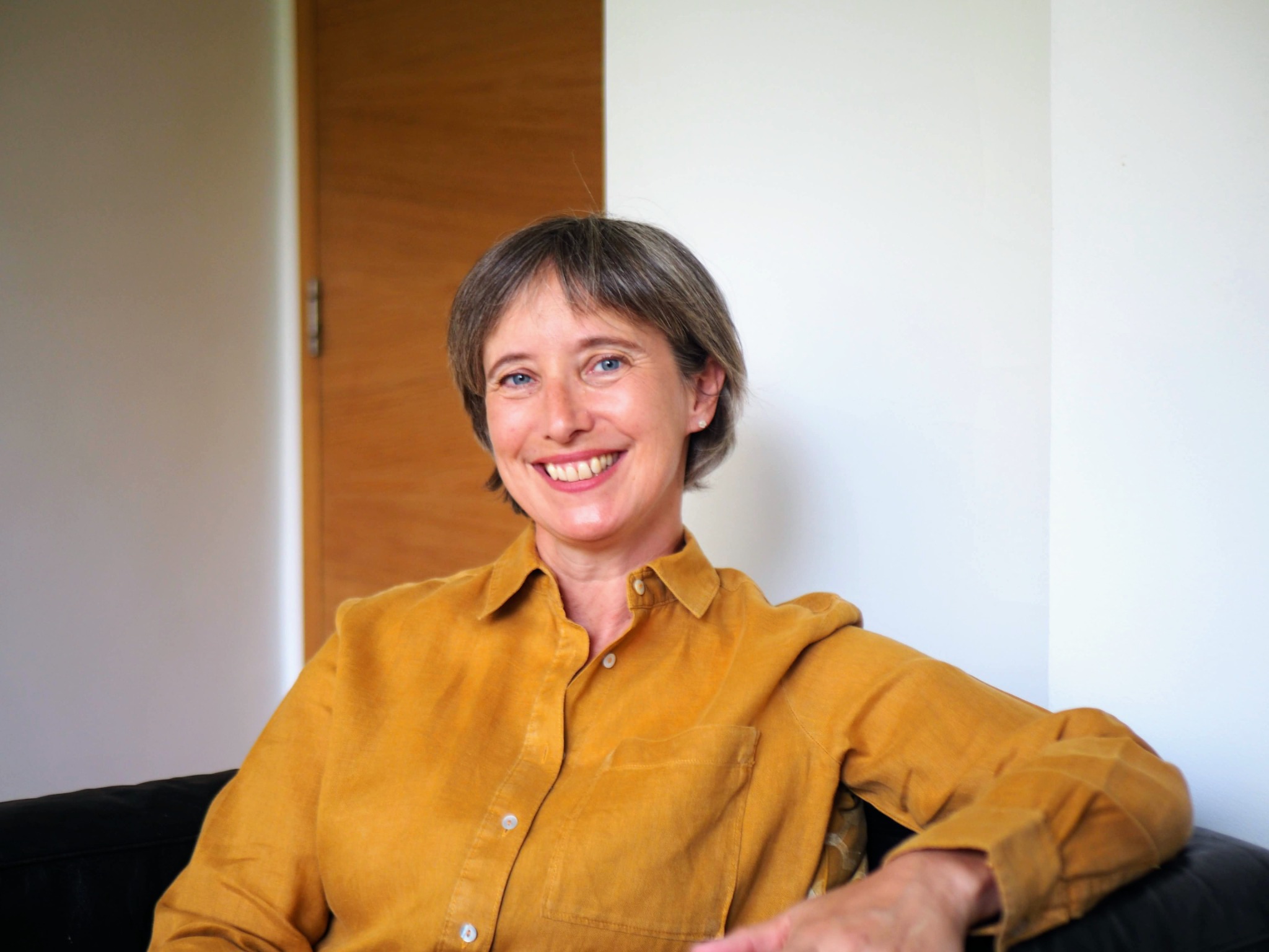 Eleanor Baker smiling, wearing a yellow shirt